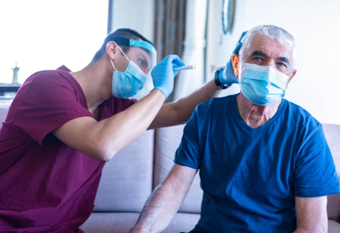Doctor examining ear